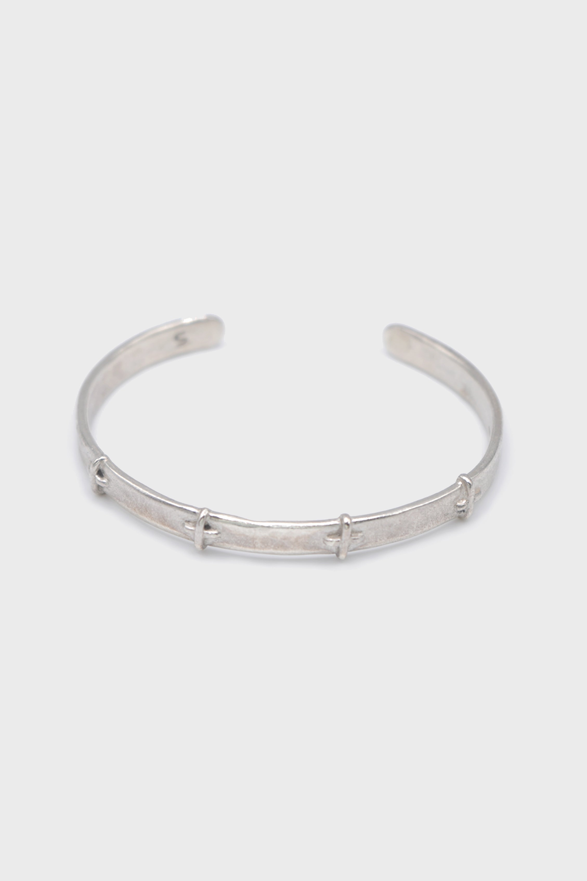 THIN SILVER STITCHED CROSS SILVER BANGLE