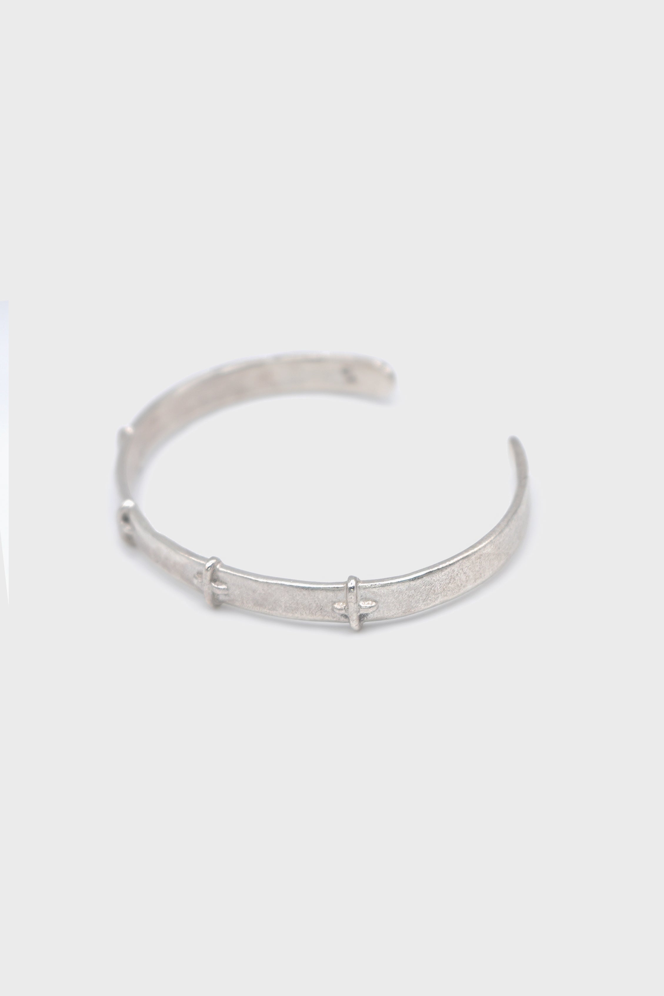 THIN SILVER STITCHED CROSS SILVER BANGLE